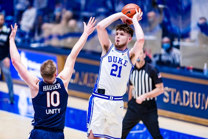 Matthew Hurt attempts a shot over Sam Hauser during Duke's win over Virginia at Cameron Indoor Stadium.